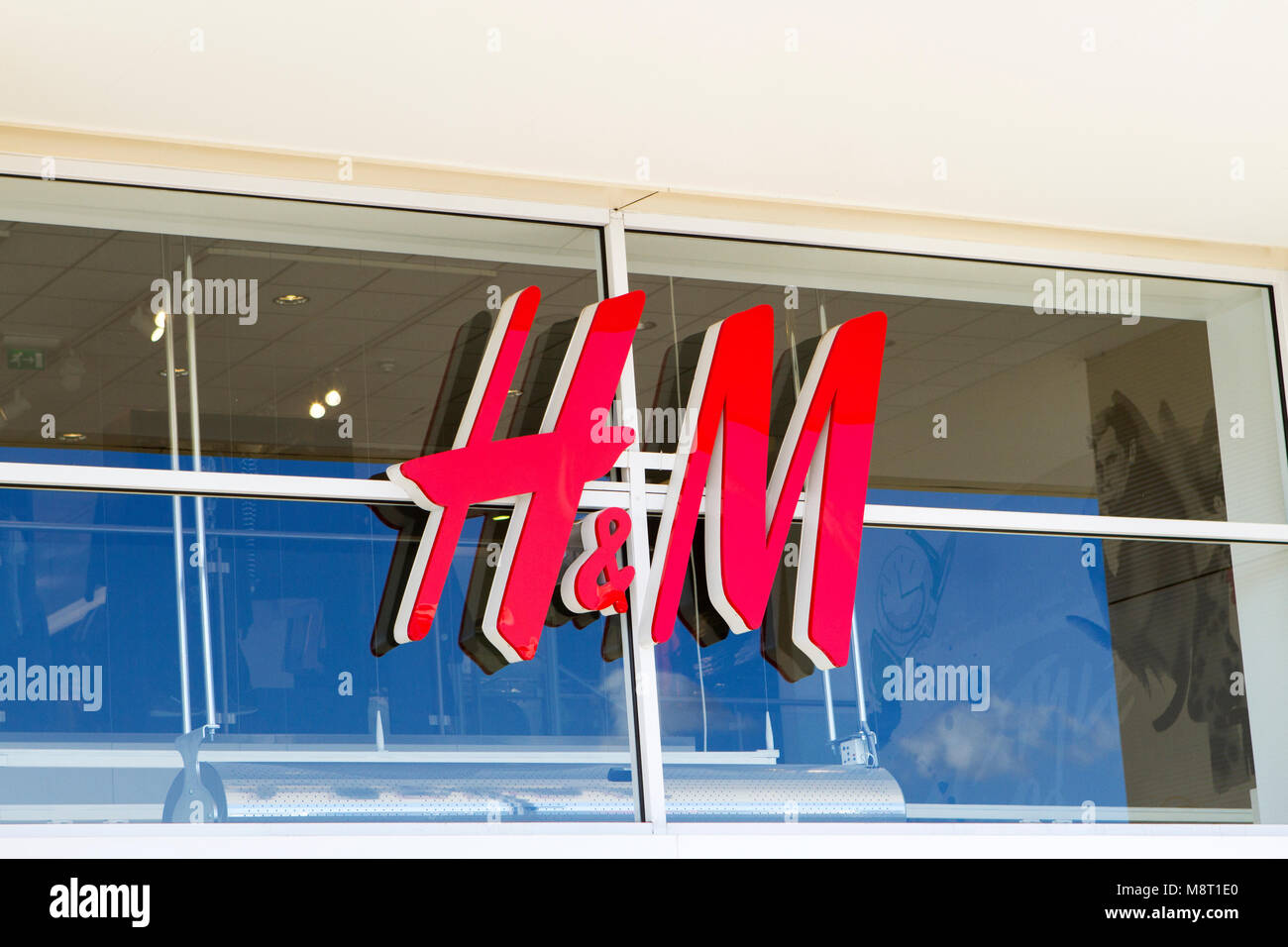 h & m clothing retail park mall shopping centre complex shop shops store stores storefront business commercial Stock Photo