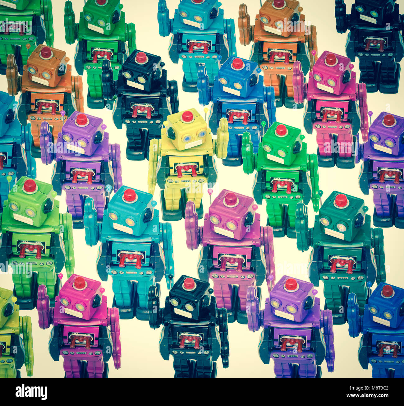 lots of color robots in a crowd with on going the other direction Stock Photo