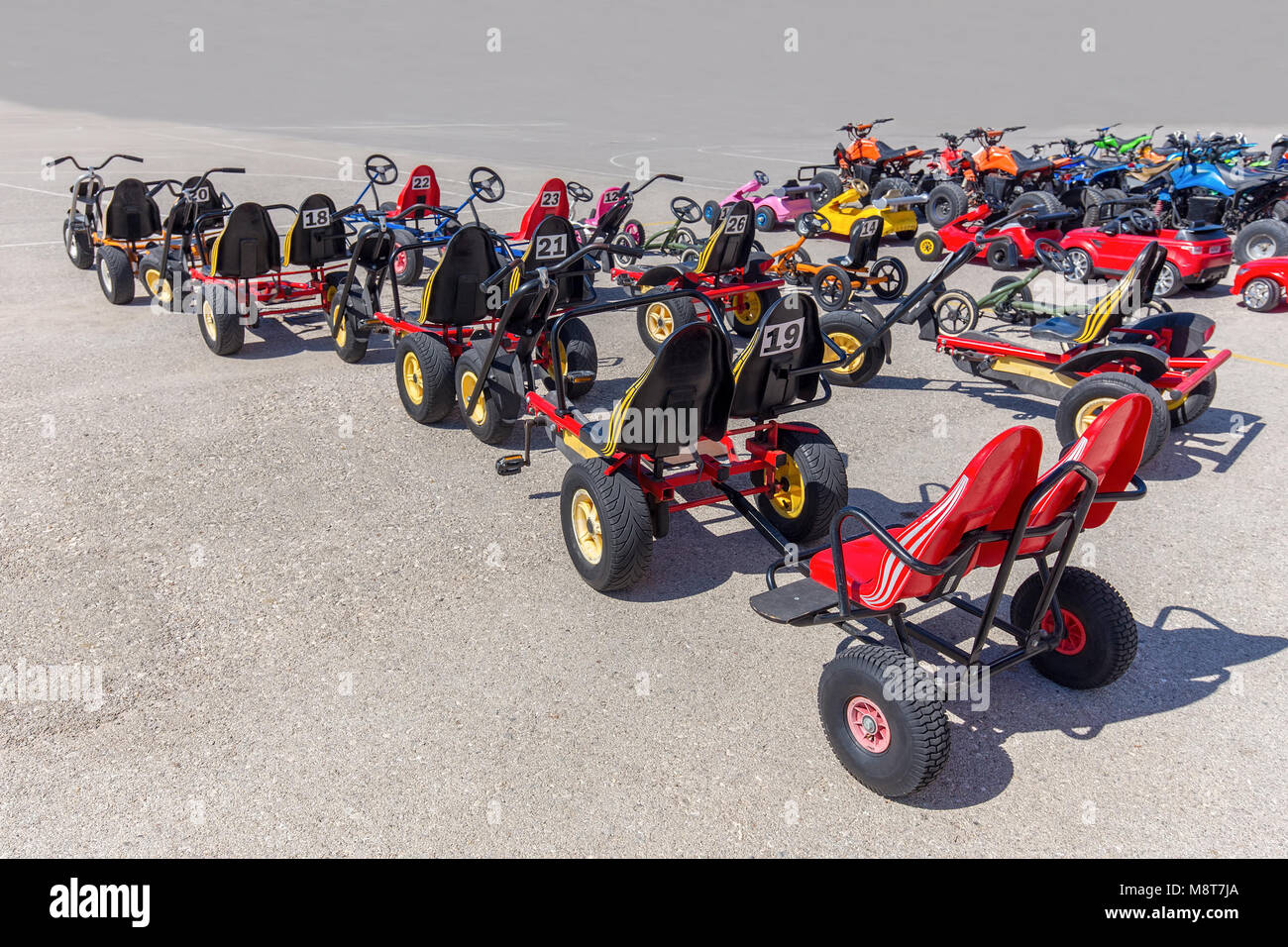 Many go-karts for children standing on asphalt terrain Stock Photo