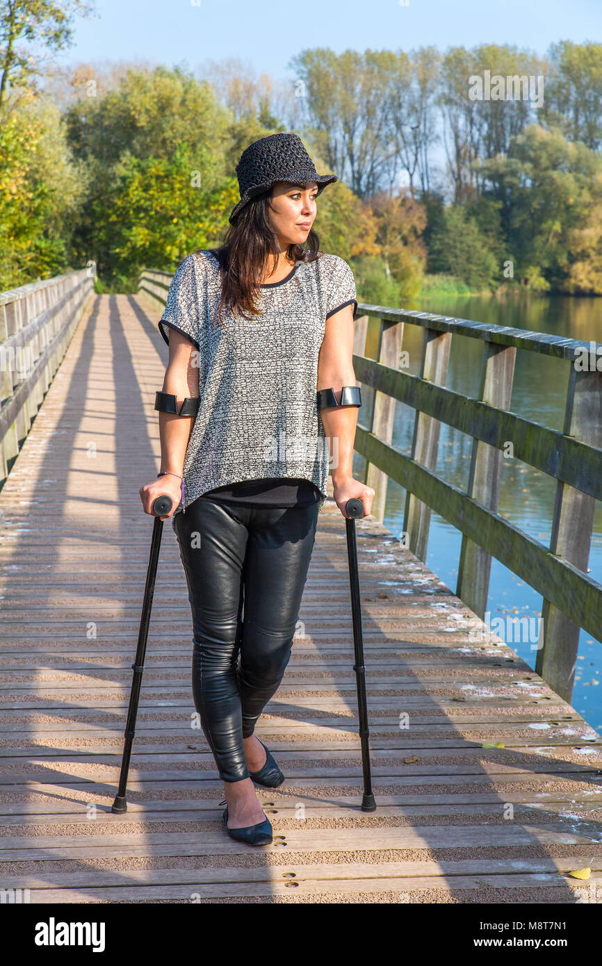 Woman standing crutches hires stock photography and images Alamy