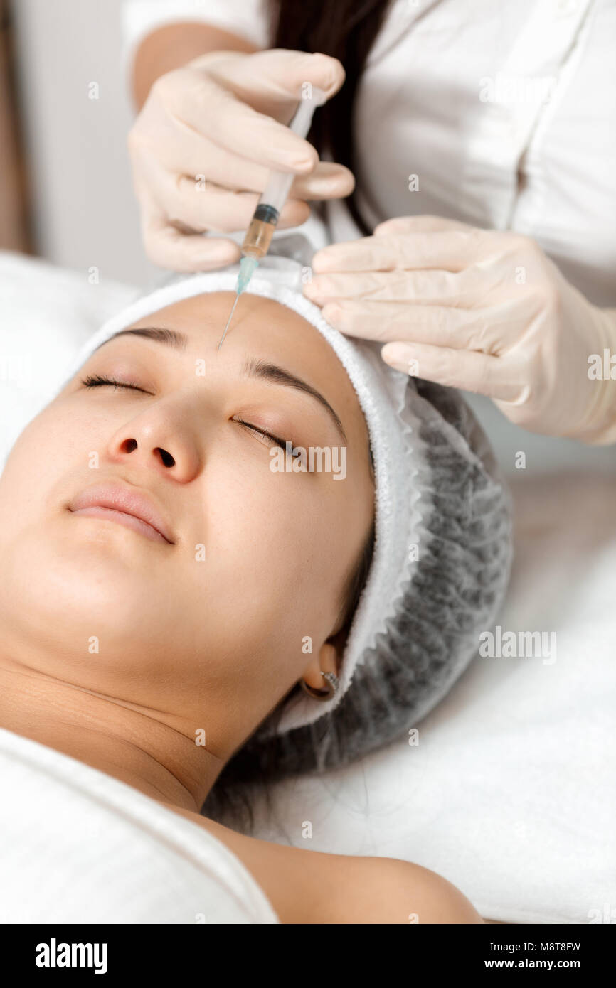 The cosmetologist performs mesotherapy procedure in the clinic Stock
