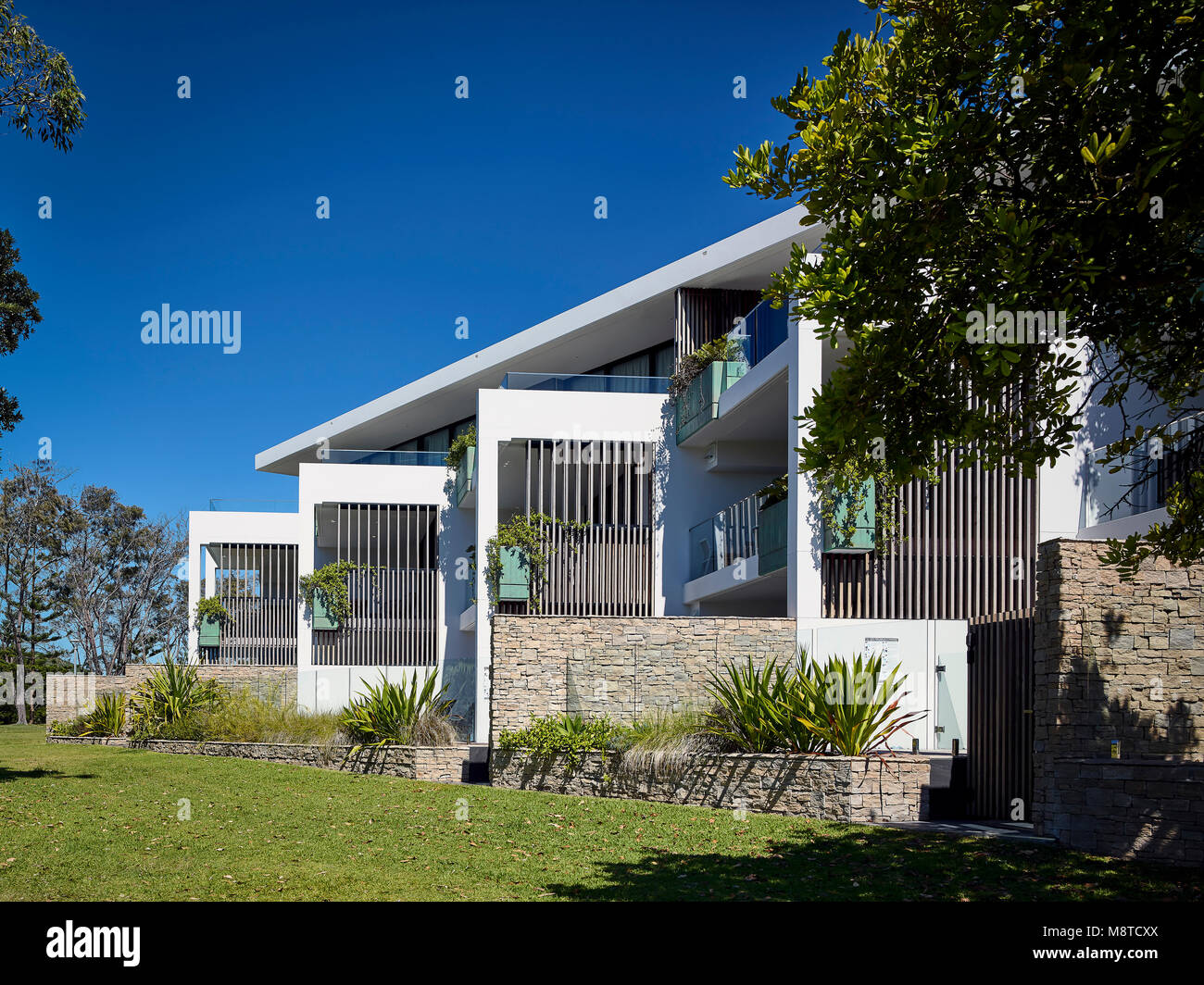 Rear of building viewed from park showing oblique balconies and privacy