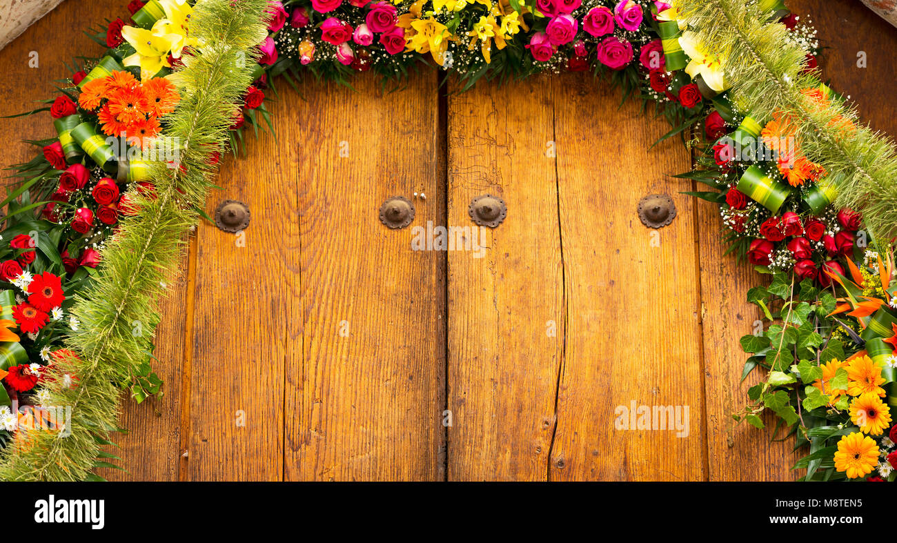 Flower arrangement on old timber door as textured background Stock Photo