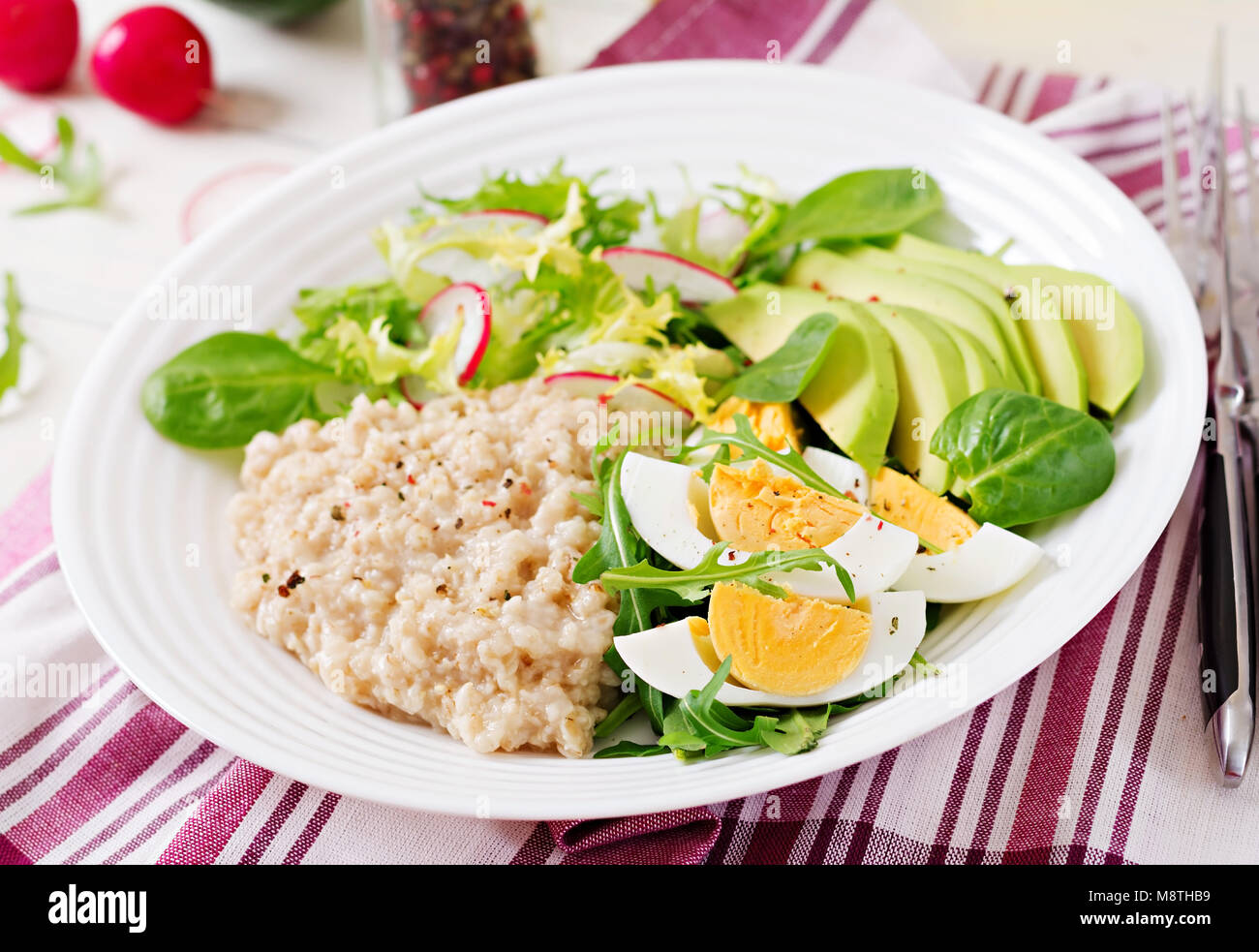 Healthy breakfast. Dietary menu. Oatmeal porridge and avocado salad and
