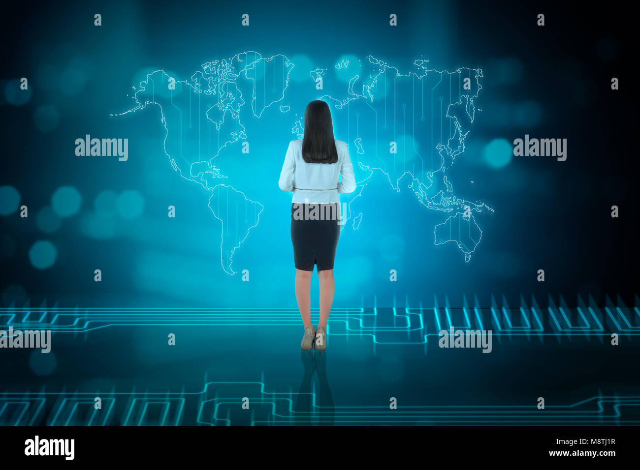 Rear view of asian business woman looking at business network on digital world map Stock Photo