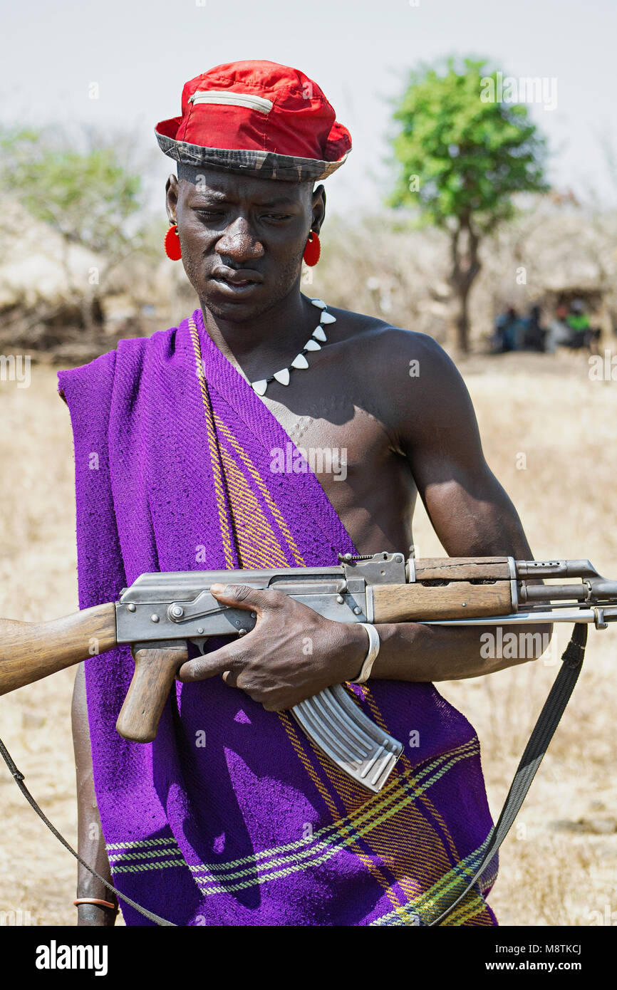 Mursi man with rifle, ethnic minorities of the lower Omo valley - Ethiopia.  Mursi are also well known for their aggressive behavior. © Antonio Ciufo  Stock Photo - Alamy