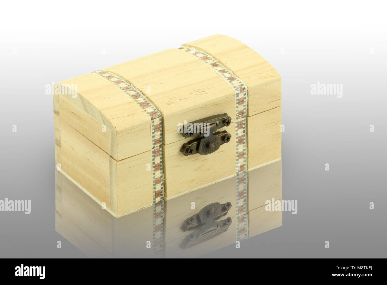 wood box on reflective surface. White background. Stock Photo