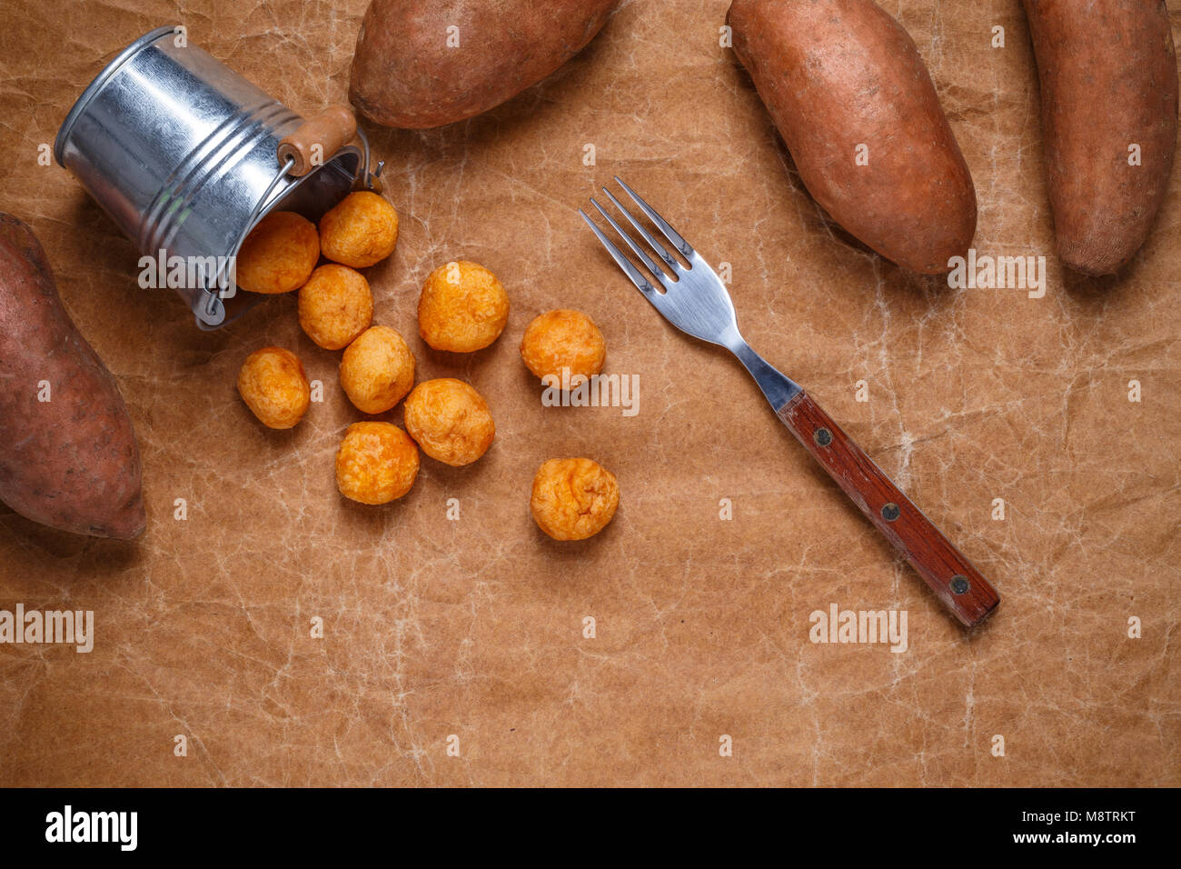 Mashed sweet potato and cheese balls on brown paper background Stock Photo