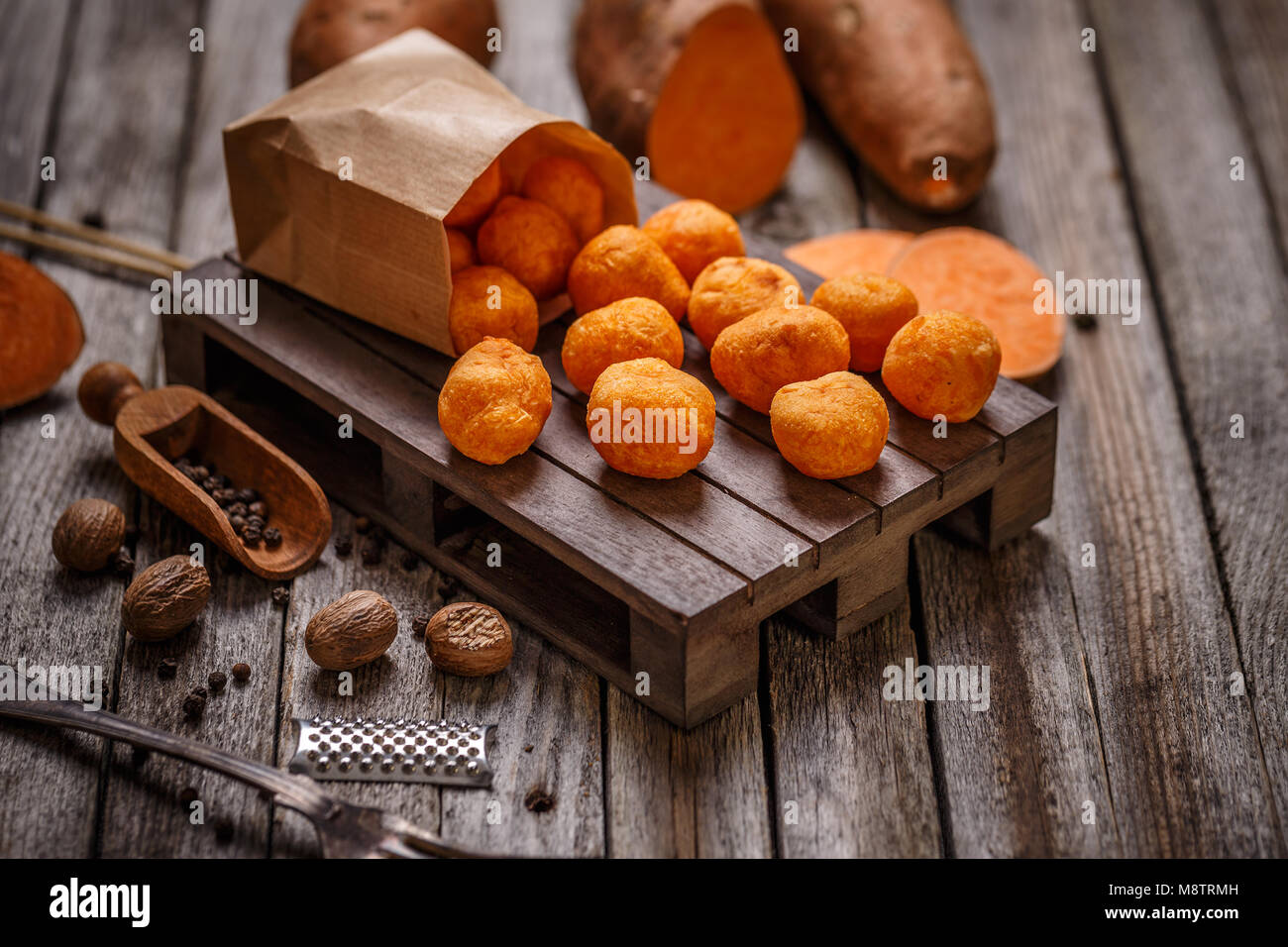 Thai fried sweet potato balls on wooden background Stock Photo