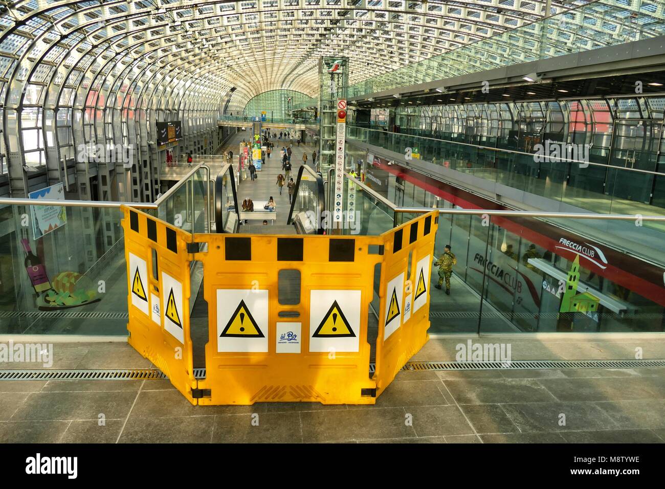Out of order escalator denied access with yellow barrier in a train station Turin Italy 23 January 2018 Stock Photo