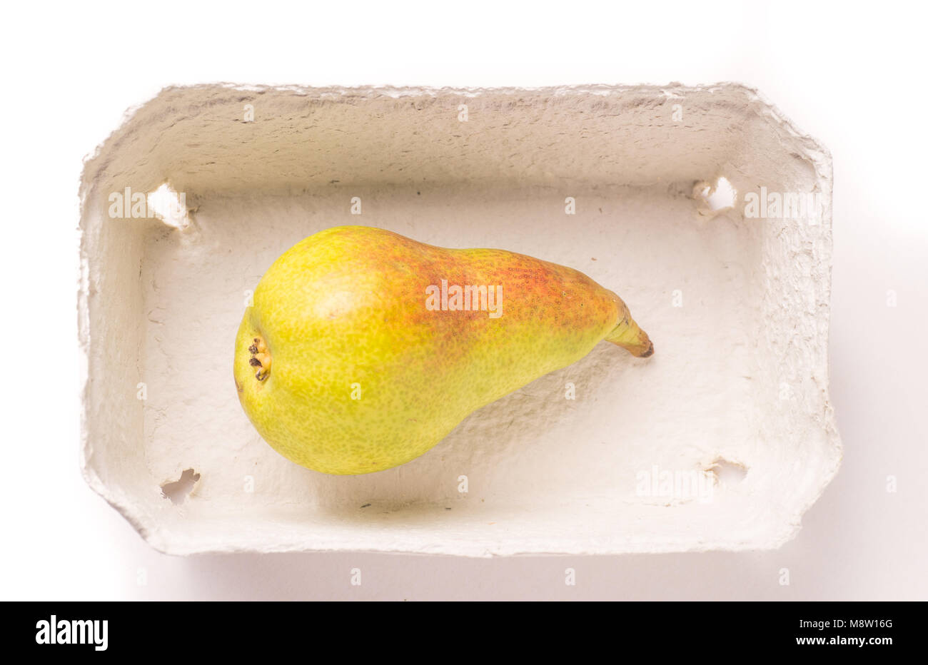 Pear Container one red green organic pear i eco friendly container Stock Photo - Alamy