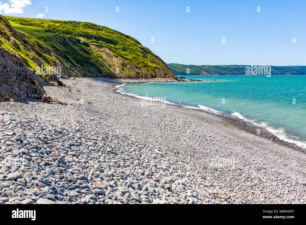 Greencliff Beach - Pebble View at Mid Tide, Looking South West towards Bucks Mills (Landscape view), Greencliff Beach, near Bideford, Devon, UK. Stock Photo