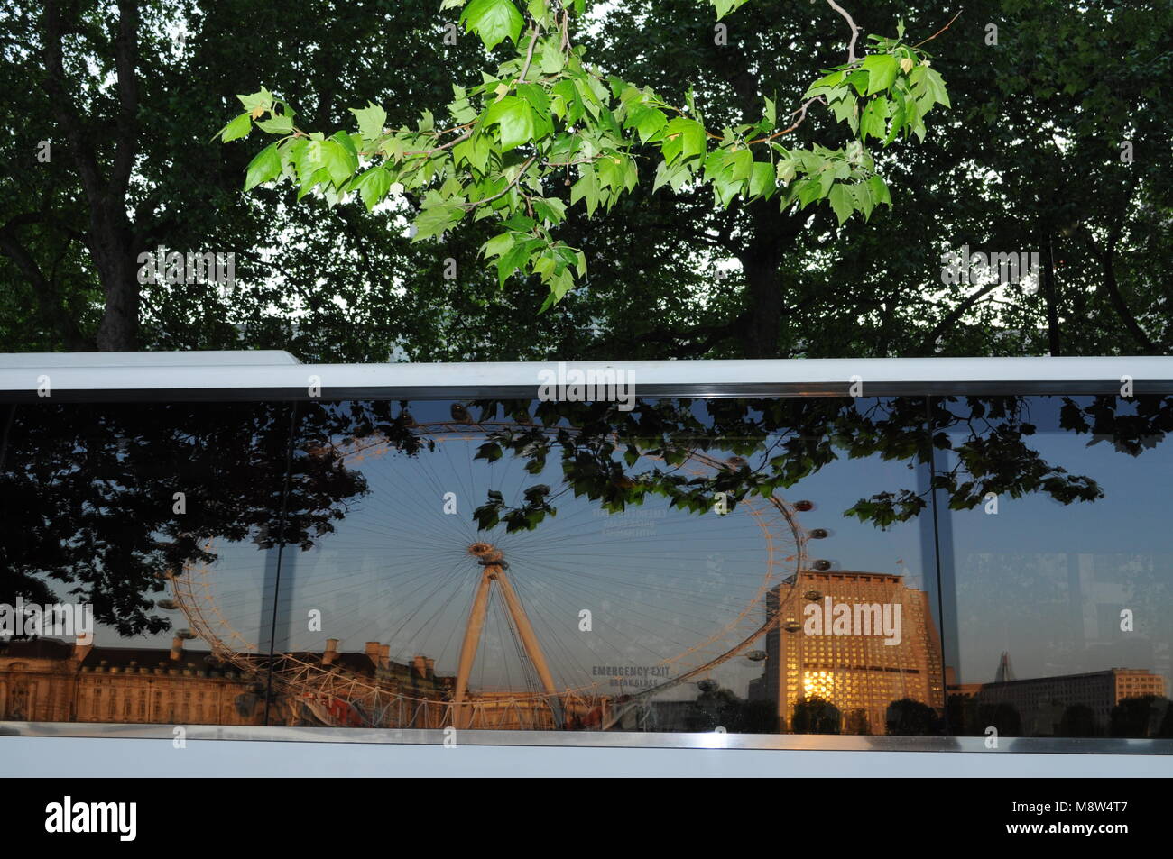 London Eye and Shell Centre reflected in a coach window, London, UK. Stock Photo