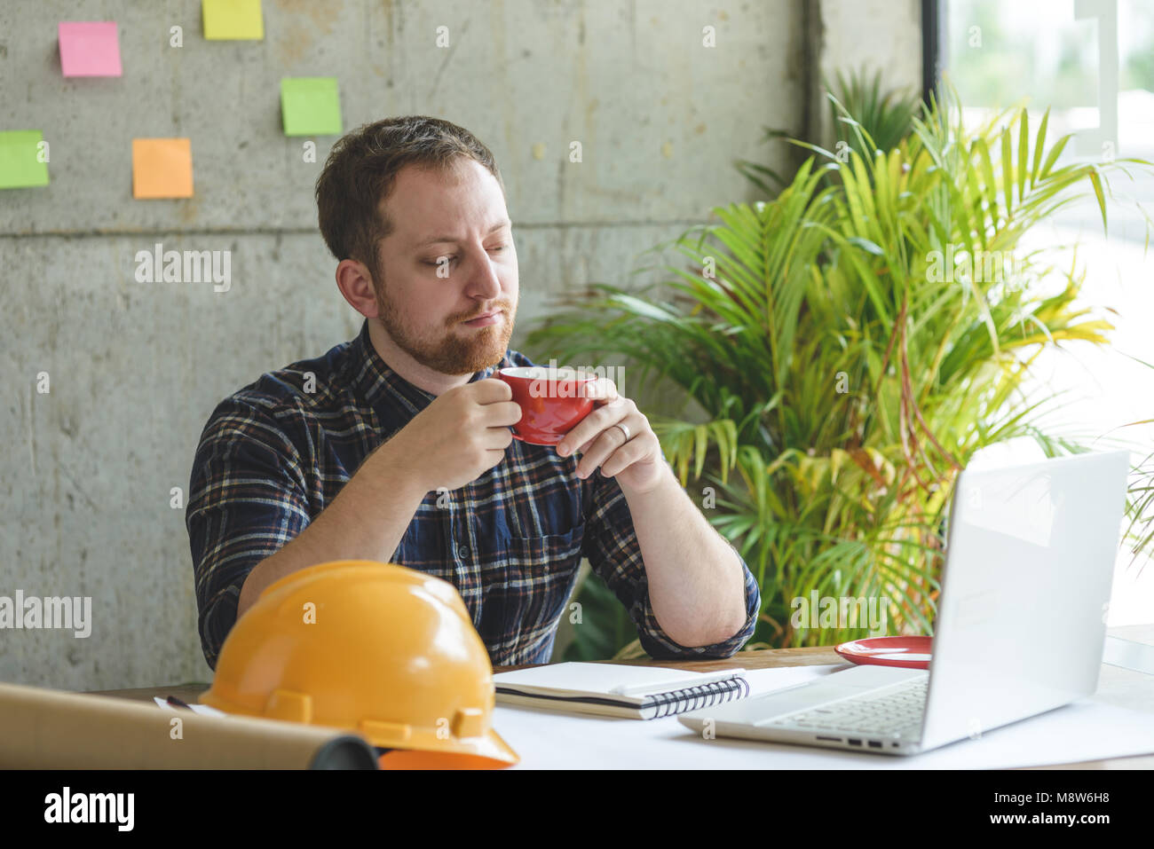 Engineer working in office and drinking coffee Stock Photo Alamy