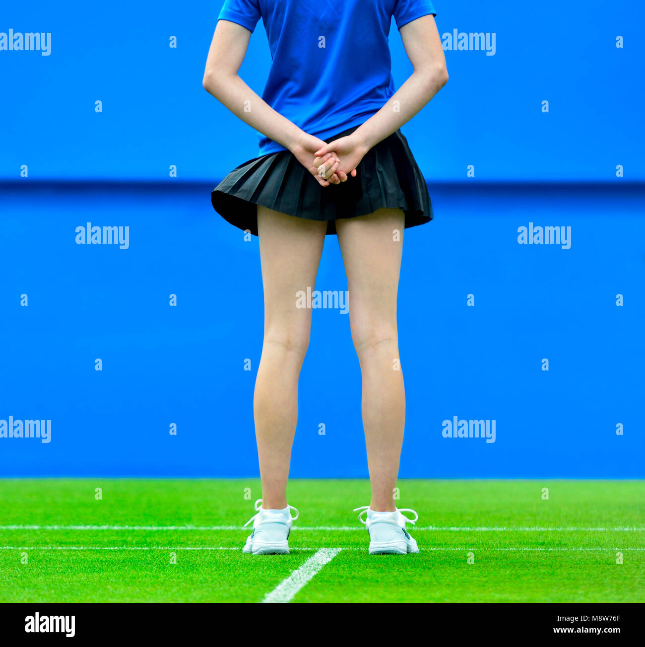 Anonymous ball girl on a grass court Stock Photo