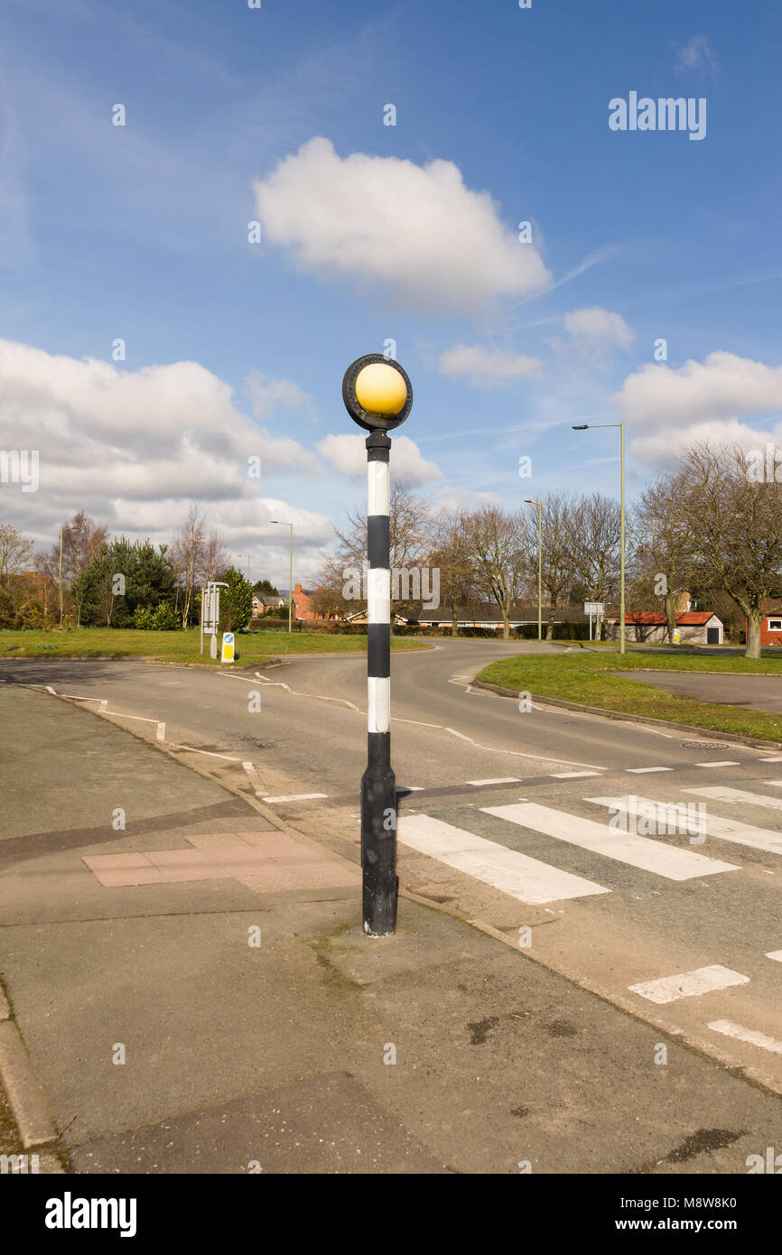 Belisha beacon an amber flashing light on a black and white pole