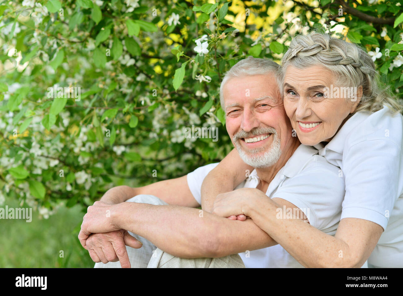 Happy couple hugging in spring park Stock Photo - Alamy