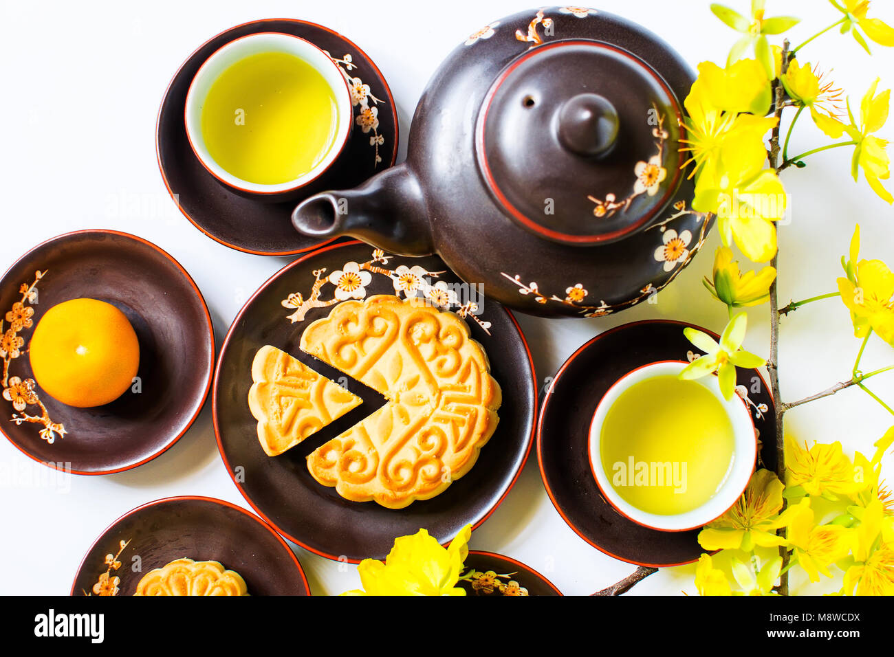 Mooncake and tea, food and drink for Chinese mid autumn festival. Isolated on white background Stock Photo