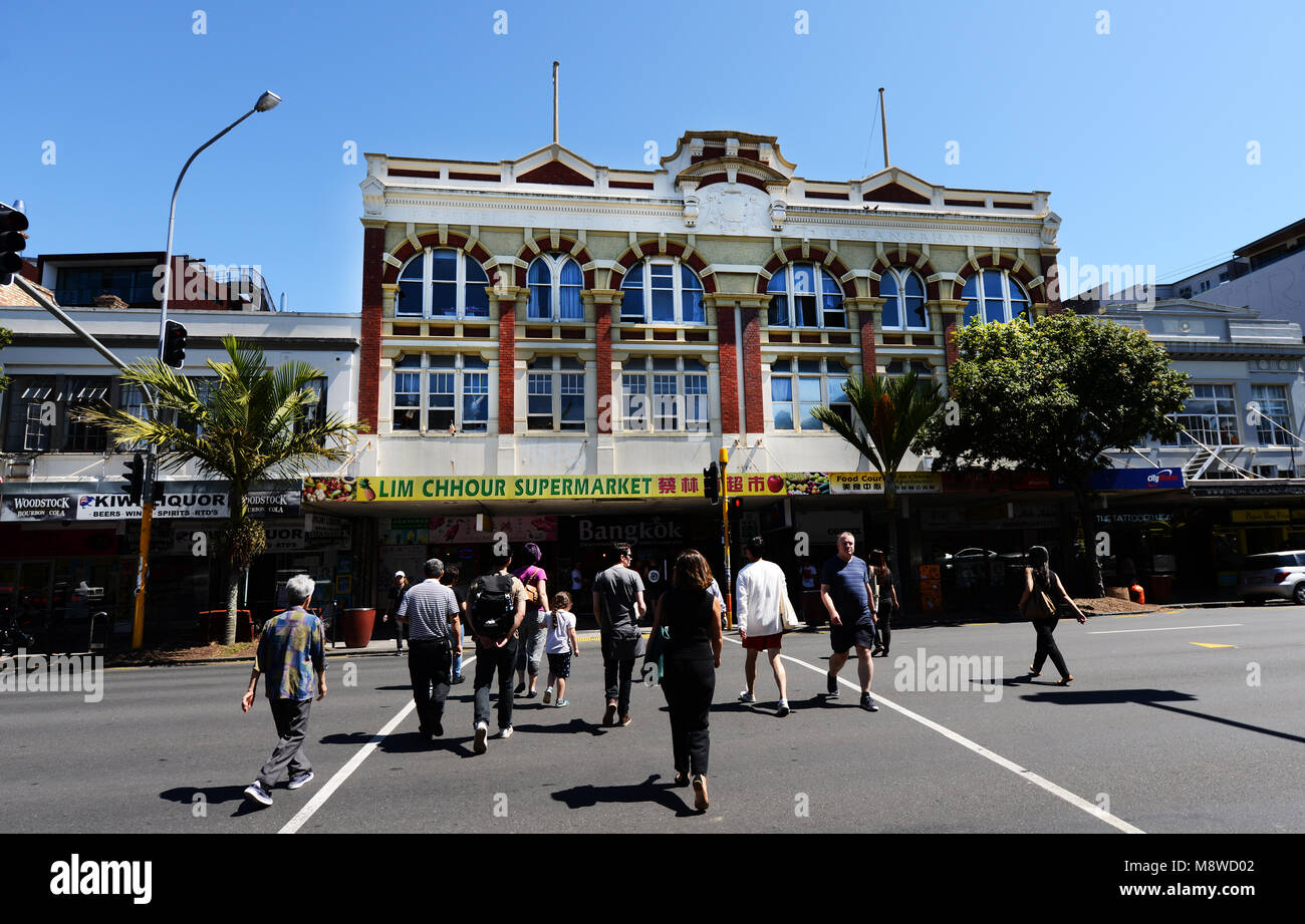 Pedestrians crossing Karangahape Rd in Auckland's Central Business district. Stock Photo