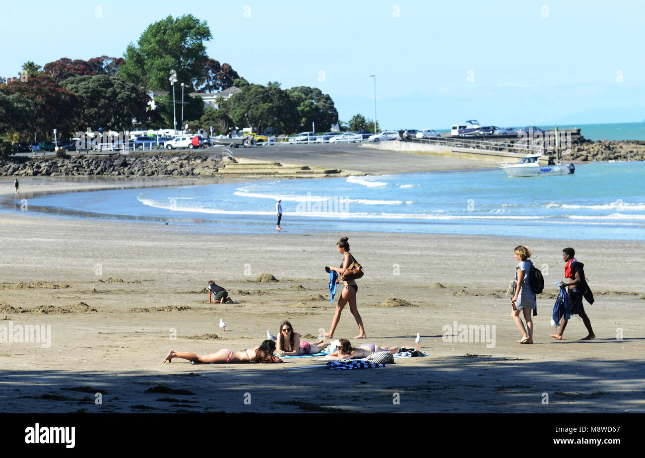 sunbathing on Takapuna beach, New Zealand. Stock Photo