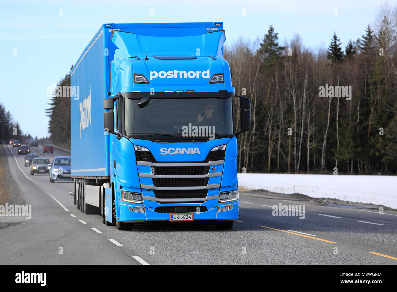 TURKU, FINLAND - MARCH 17, 2018: Next Generation Scania R500 semi trailer of FE-Trans for PostNord Logistics on the road to deliver a load in South of Stock Photo