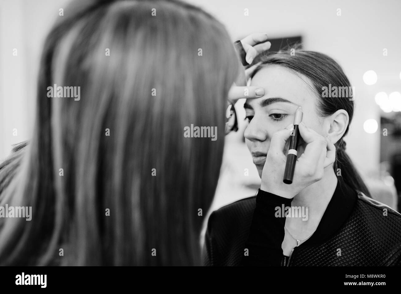 Make up artist work in her beauty visage studio salon. Woman applying