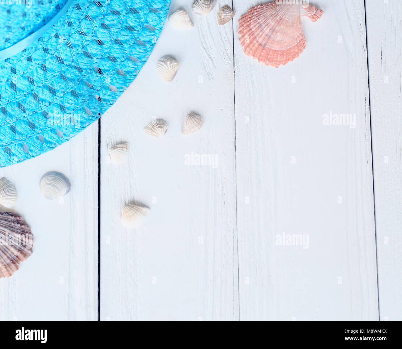 straw hat and seashells on wooden background.photo with place for text ...