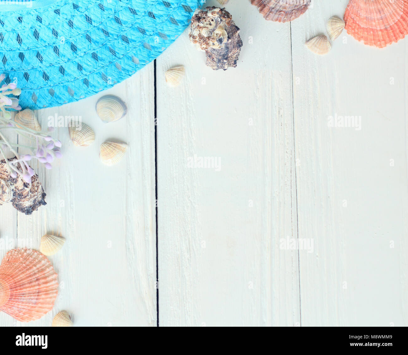 beach straw hat and seashells on a wooden background.photo with place ...