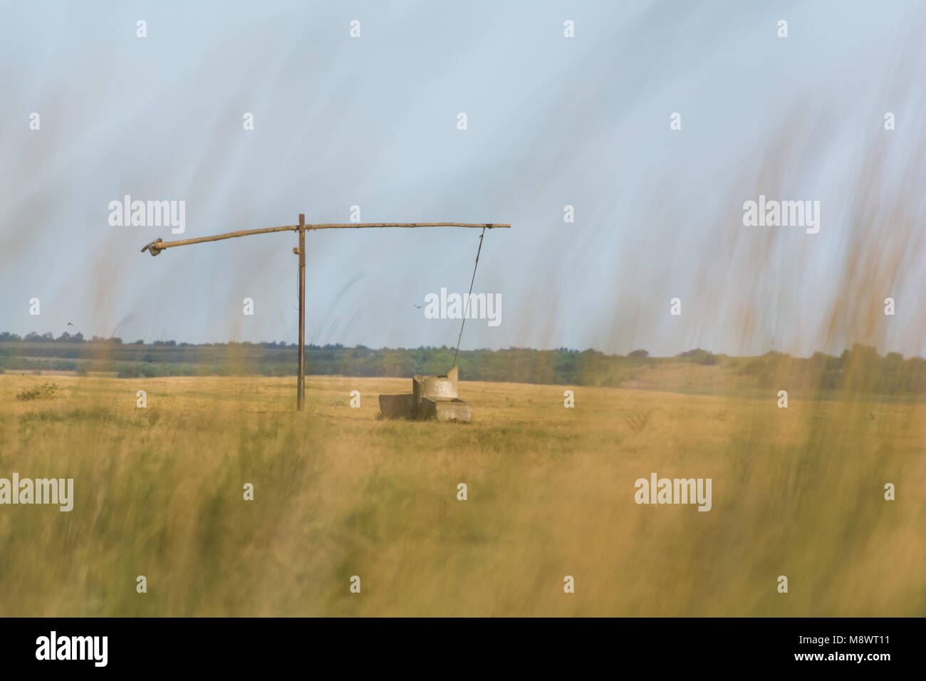 Old,traditional, wooden shadoof in the great plains of southern Romania Stock Photo