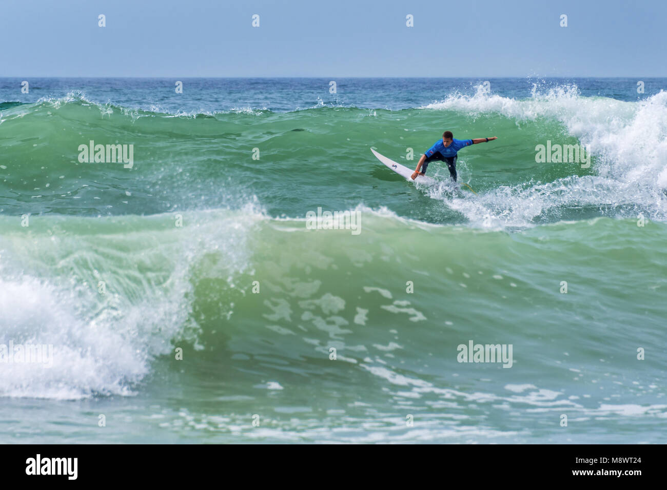 Surfer riding a huge wave during  World surf league competition in Lacanau, France Stock Photo