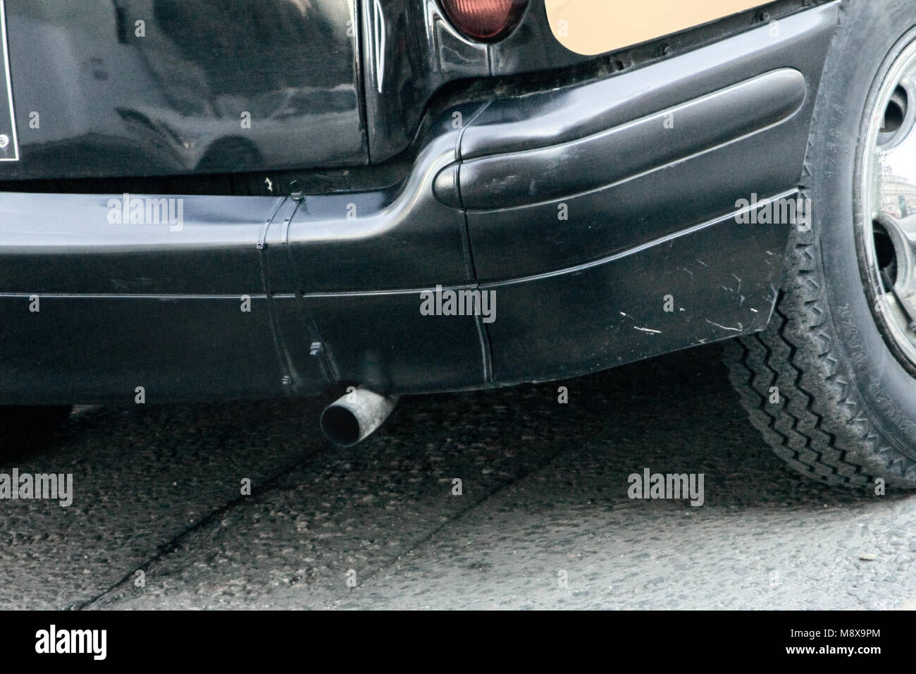 Rear of a taxi, showing exhaust, depicting pollution Stock Photo