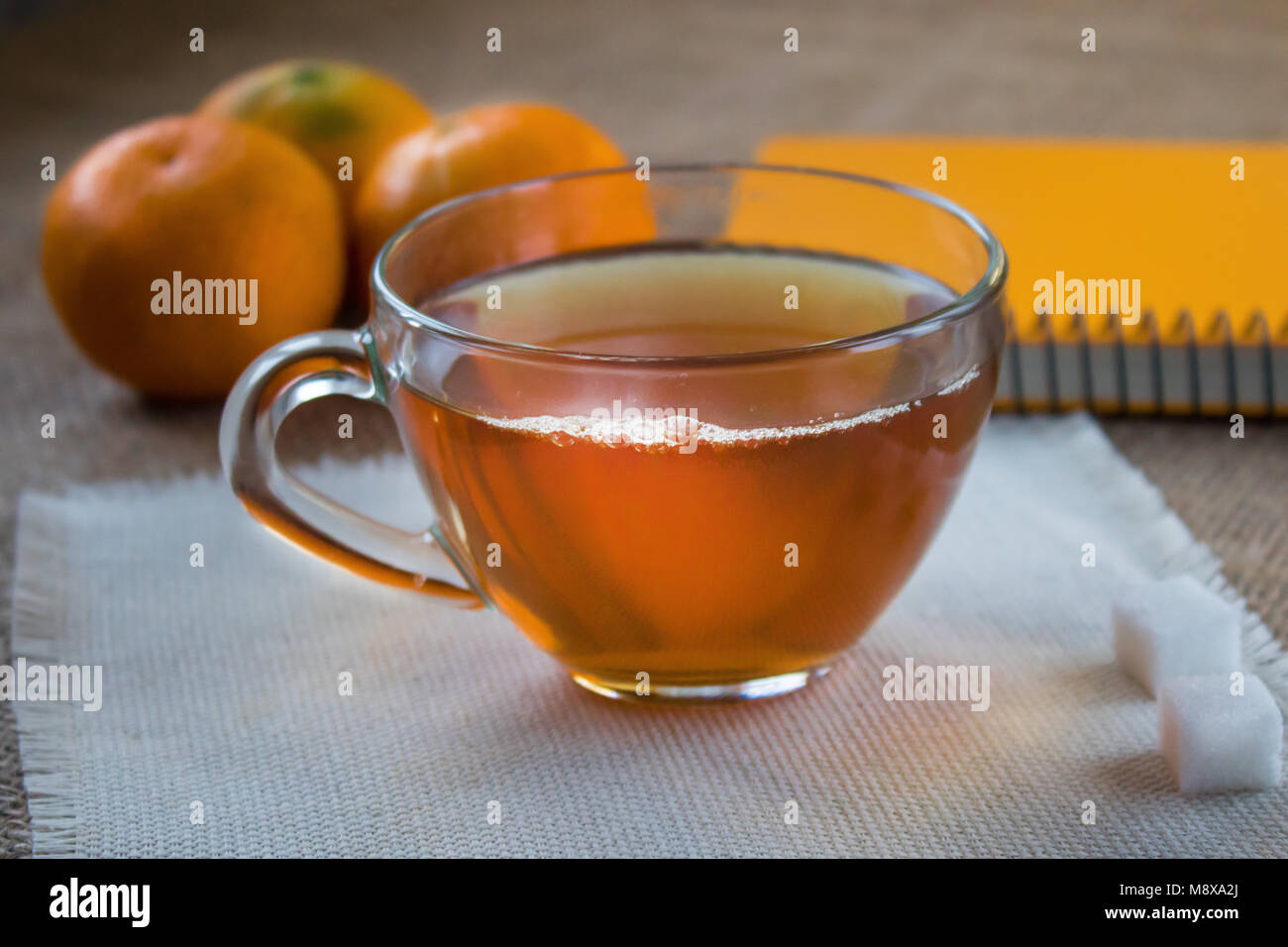 Morning cup of tea. Mandarins on the table. Notepad to write plans for the day. Stock Photo