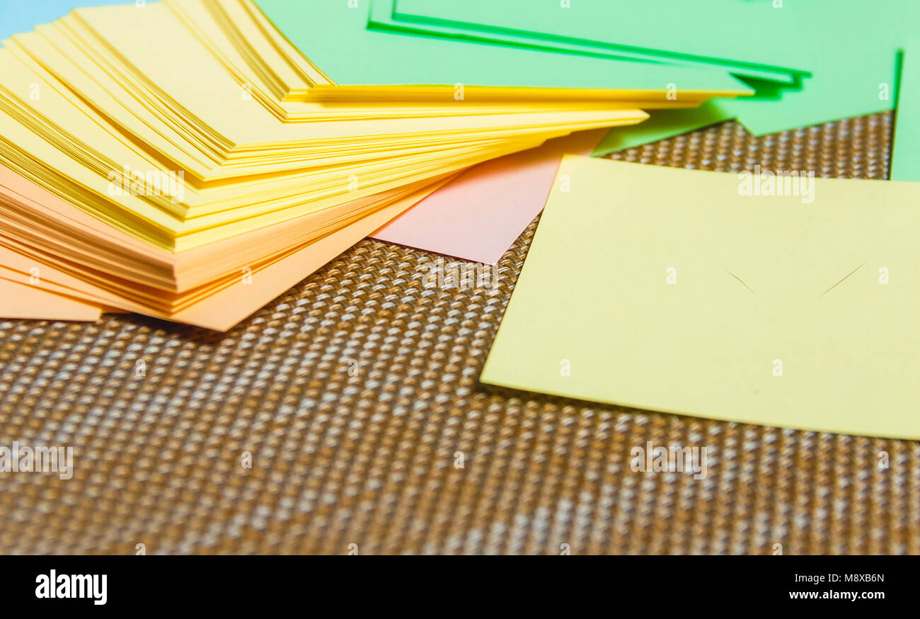 Stationary, Stack of Blank Colored Sticker on Brown Board. Time-management, Planning Stock Photo