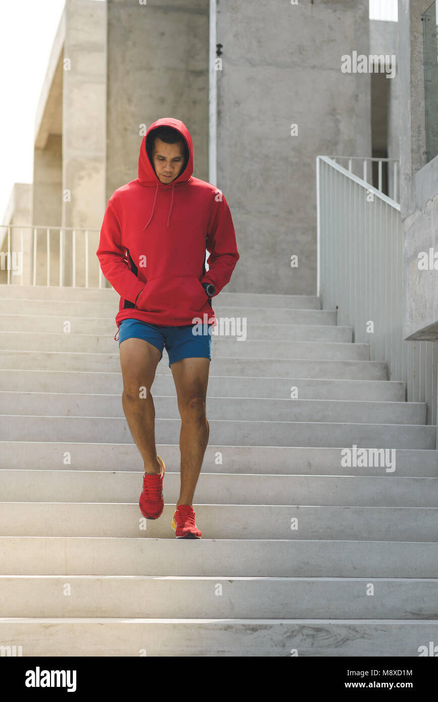 Urban athlete running upstairs. Sporty man working out outside and