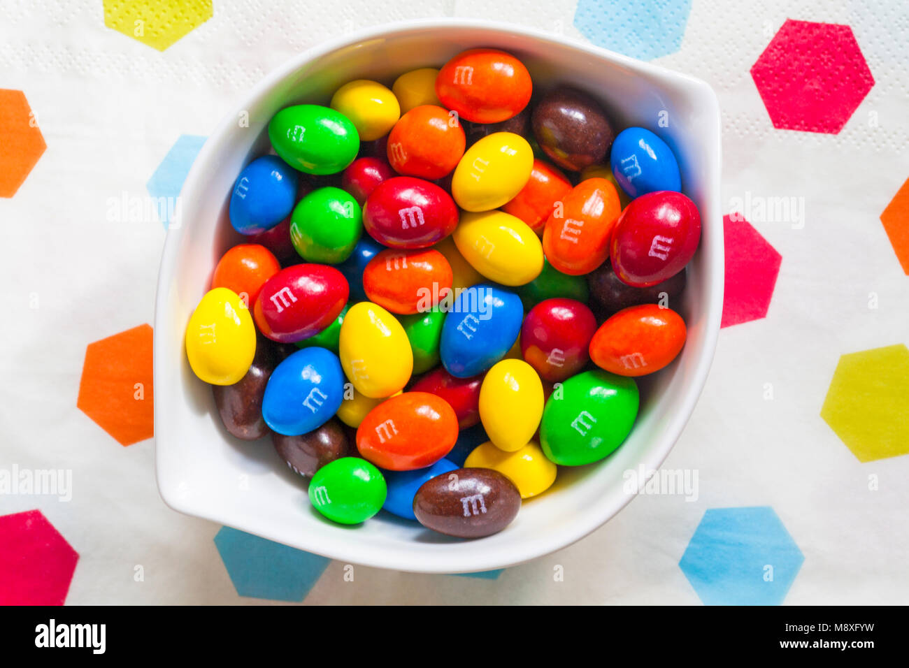 Travel Retail Edition Almond M&Ms in bowl Stock Photo - Alamy