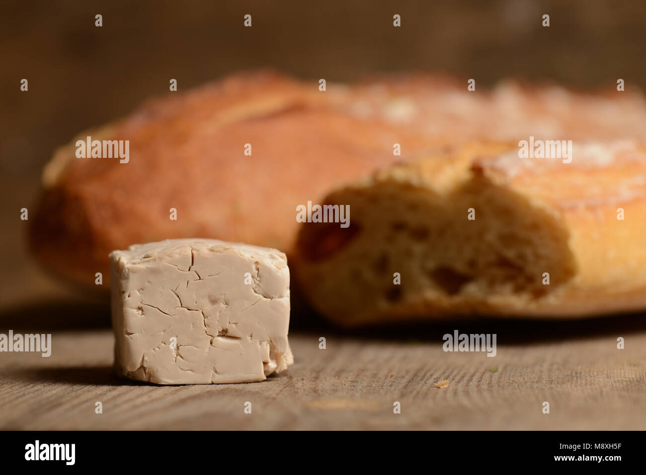 French Bread and fresh yeast on wood Stock Photo
