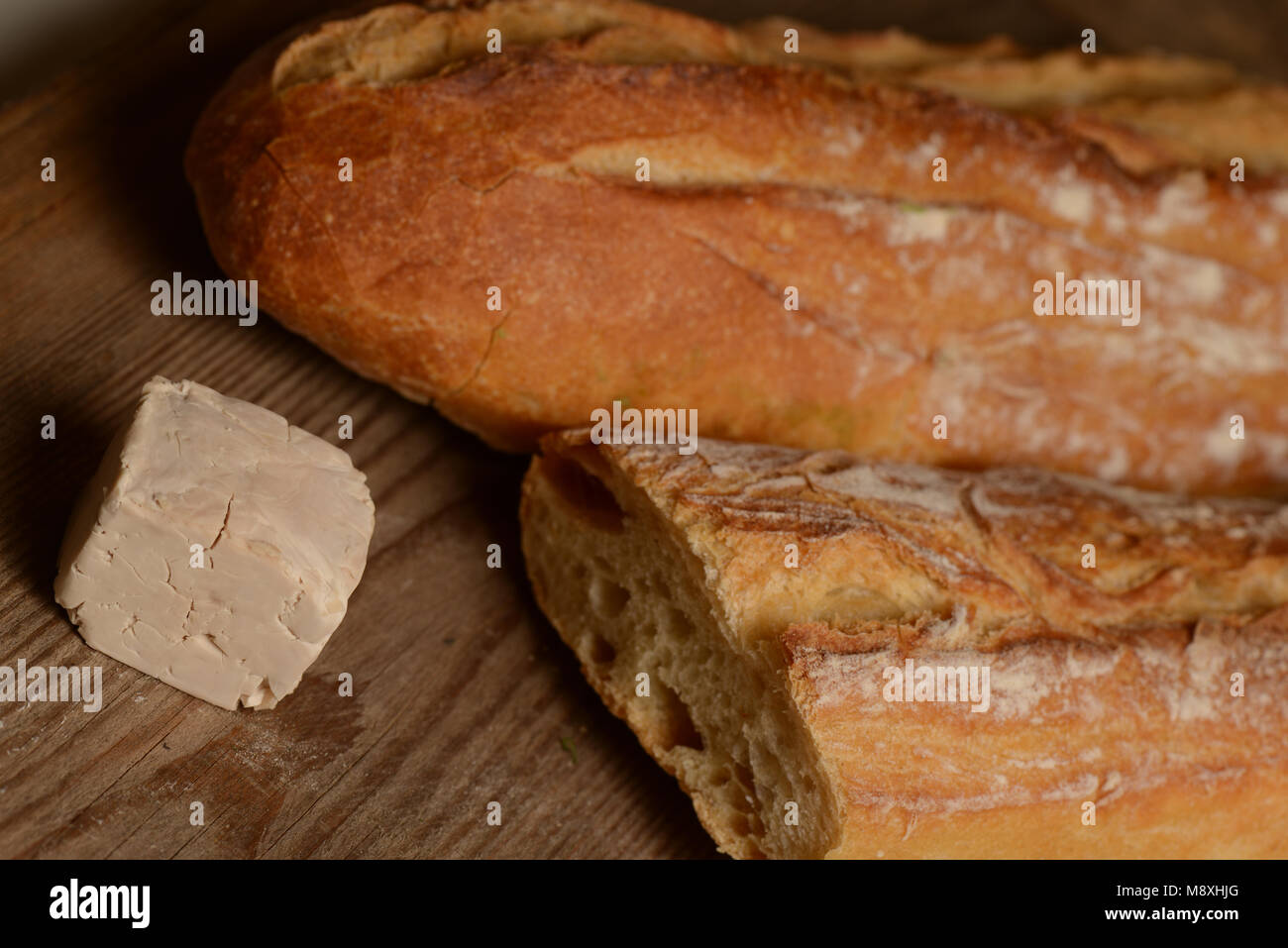 French Bread and fresh yeast on wood Stock Photo