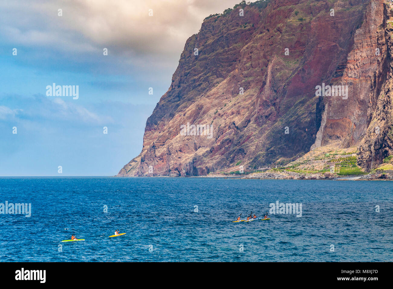 Kayakers head towards the dramatic cliffs of Cabo Girão near Câmara de Lobos, Funchal, Madeira Stock Photo