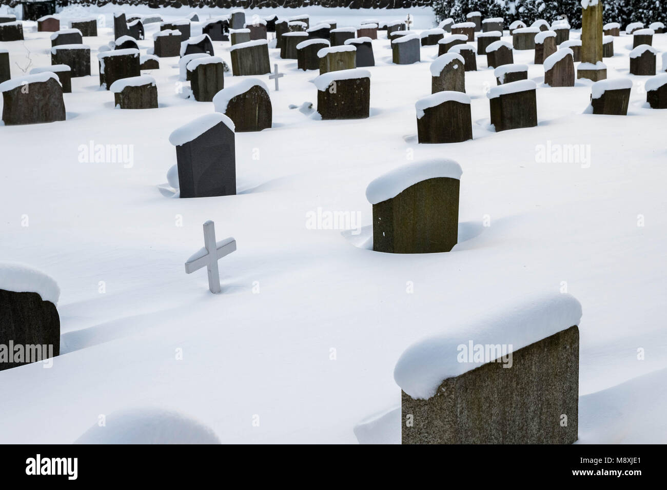 Grave stones in winter, covered in snow Stock Photo Alamy