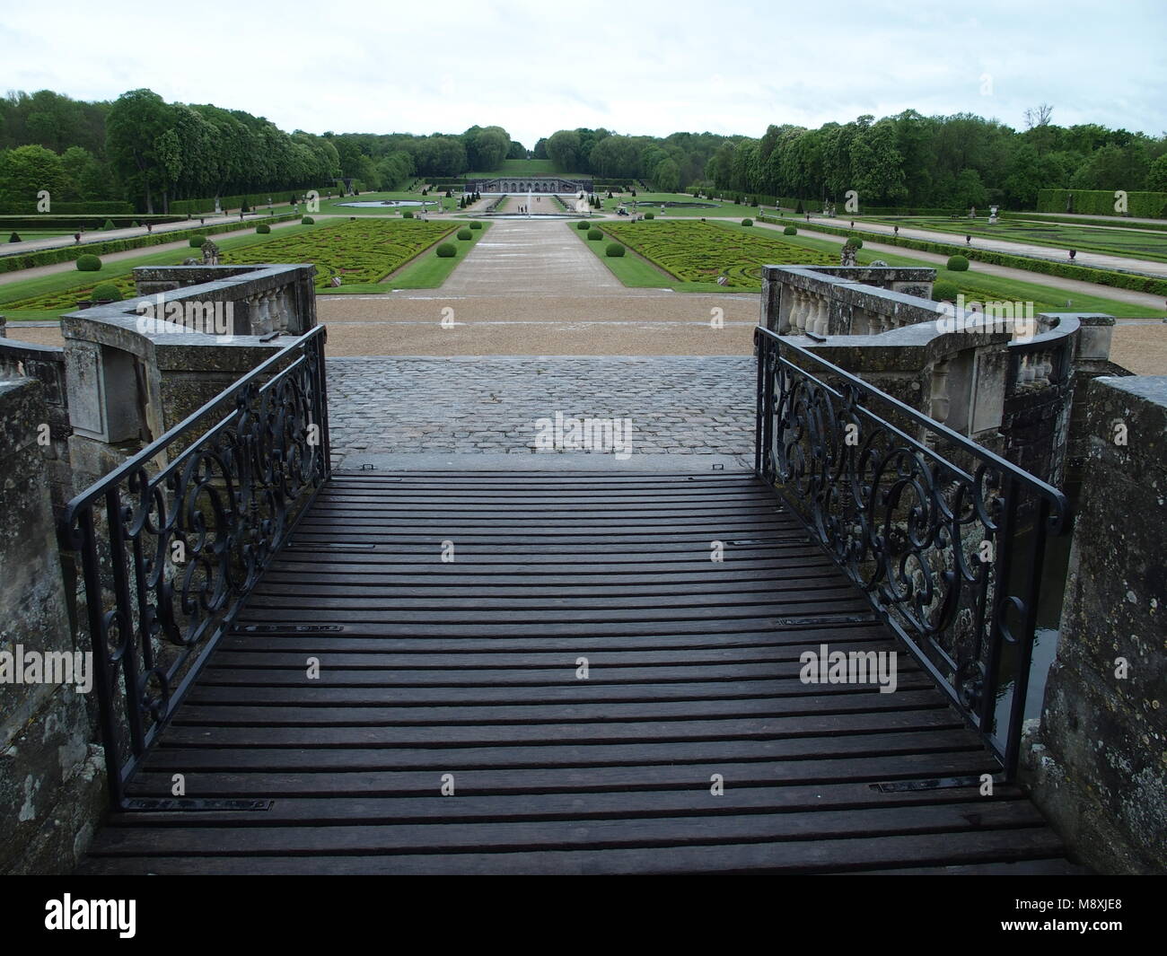 French formal garden park landscapes near Maincy city seen from bridge of chateau de vaux le vicomte castle in France with cloudy sky in 2015 warm spr Stock Photo
