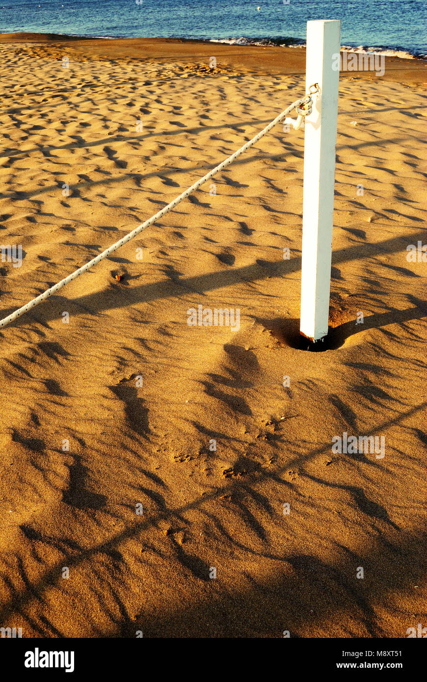 summer sea, white pole with rope on the beach at dawn, concept for ...