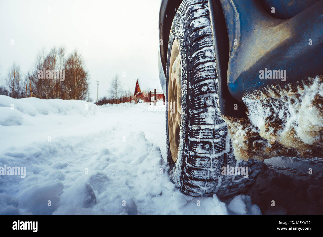 Closeup of car tires in winter on the road covered with snow Stock ...