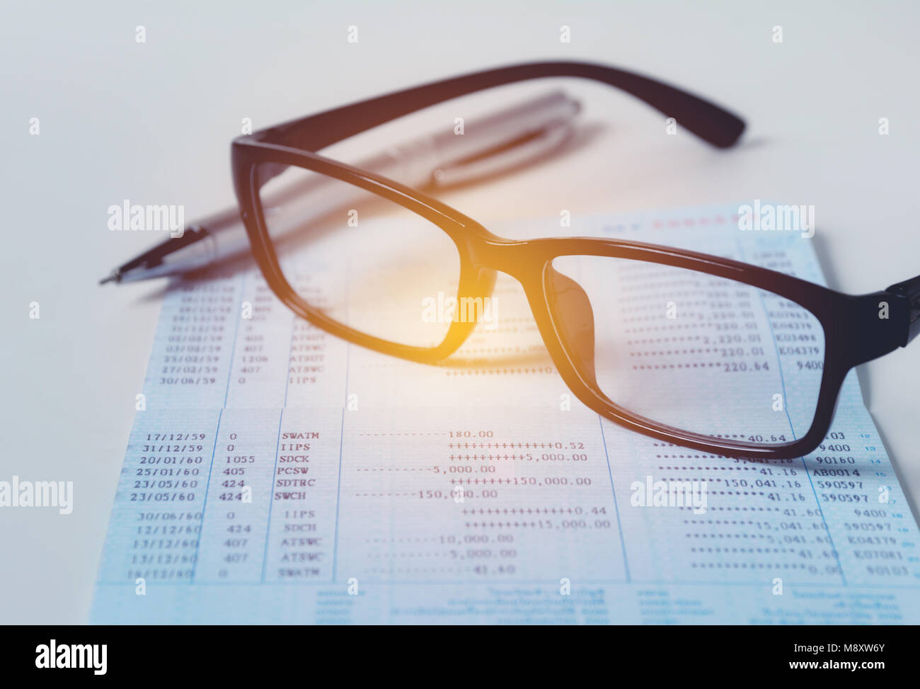 Glasses with bank account passbook for savings financial and accounting concept. Stock Photo