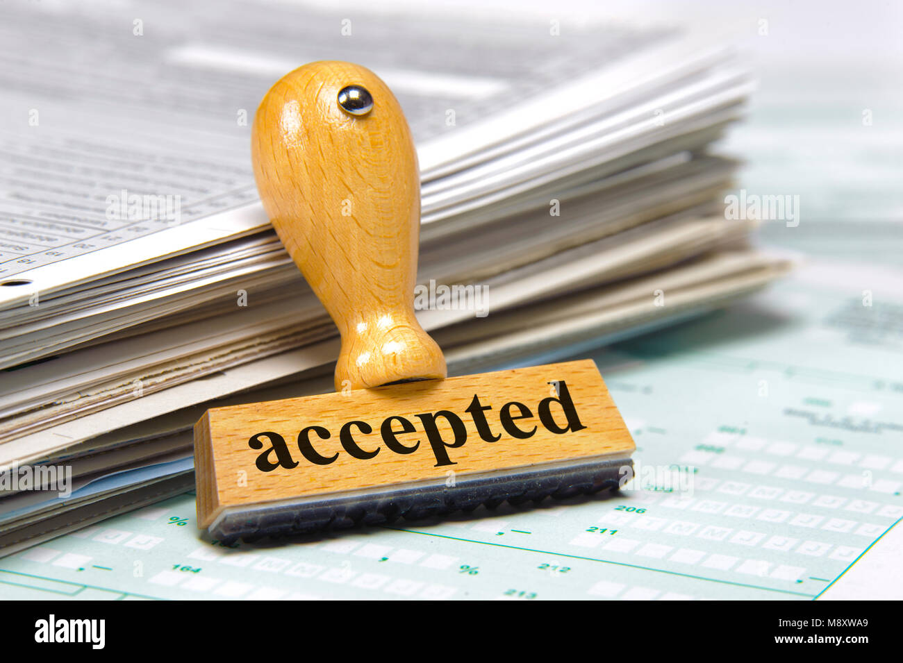 accepted printed on rubber stamp laying on documents Stock Photo
