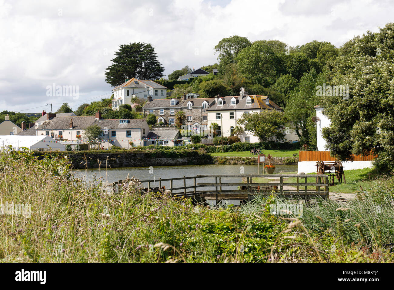 The Beautiful and unspoilt village of Pentewan.  In the foreground can be seen the decayed lock gates which once gave shipping access to the harbour. Stock Photo