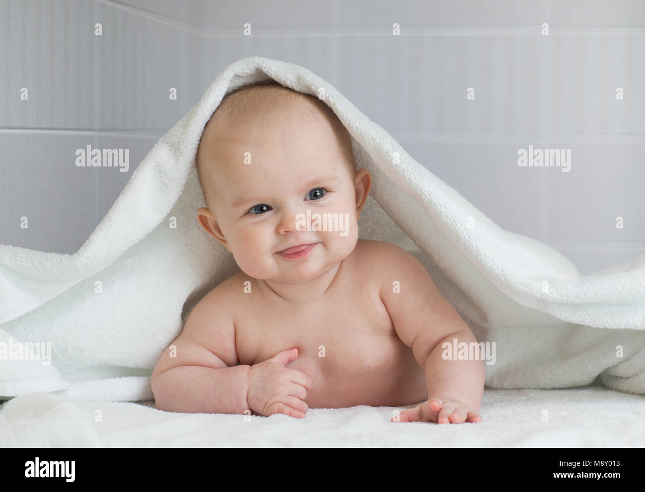 cute baby in white bathing towel in bathroom Stock Photo Alamy