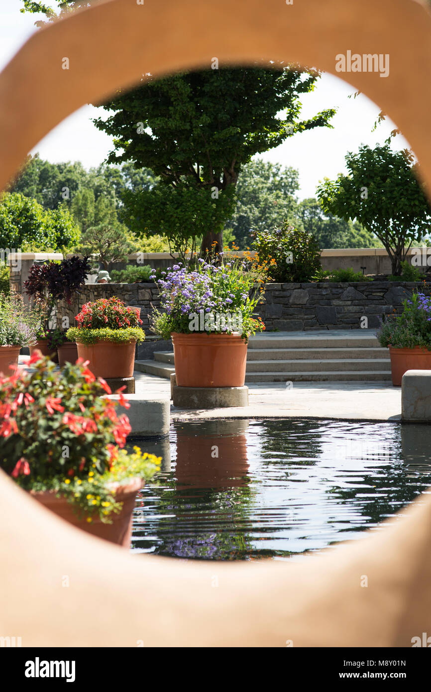 Flowers surround a water feature at the botanical gardens in Asheville, North Carolina. Stock Photo