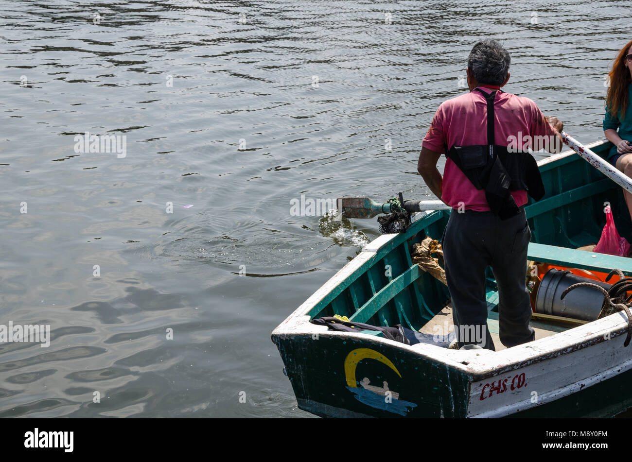Old man driving a boat at sea Stock Photo - Alamy