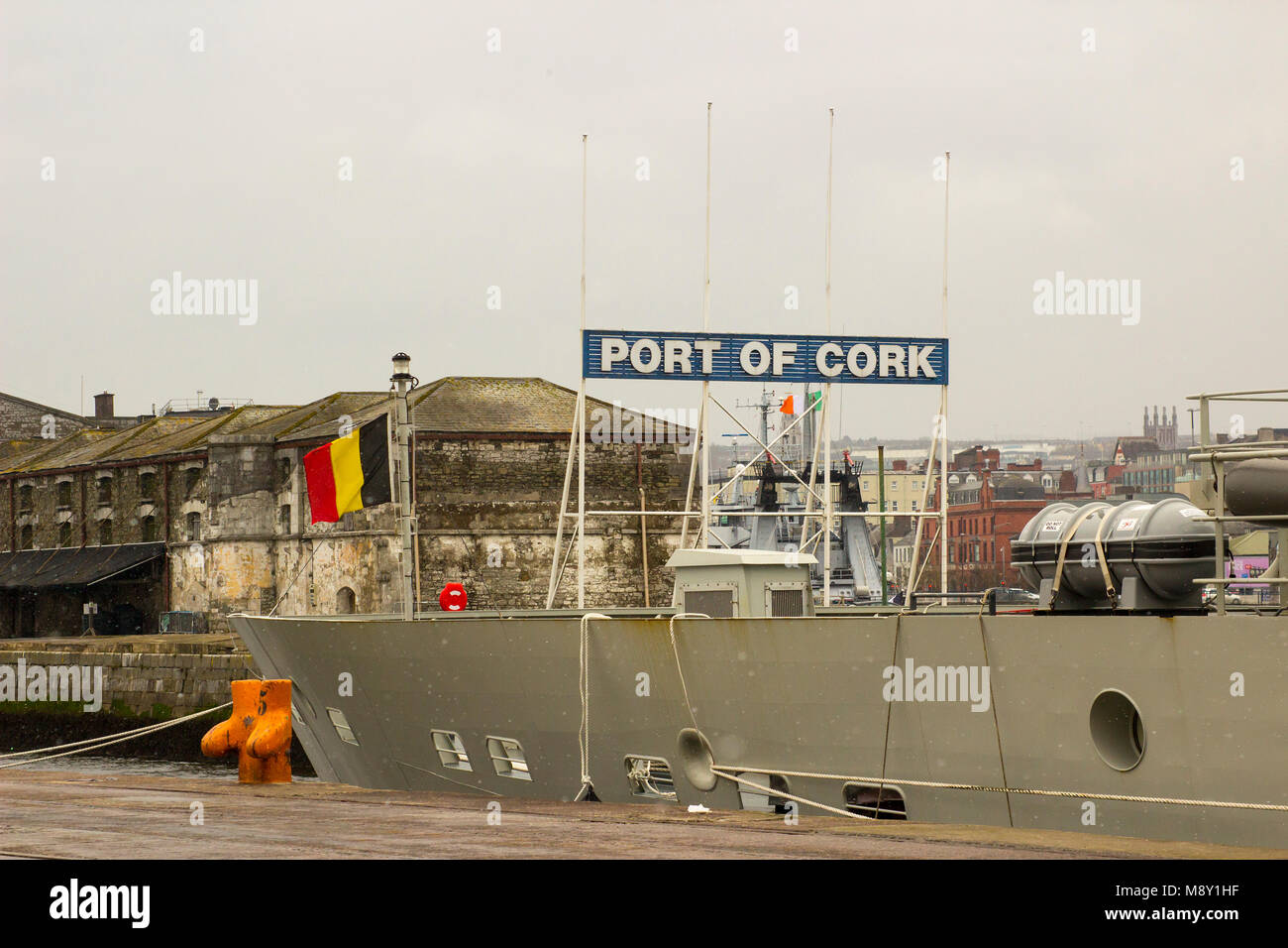 The Belgian national flag flying on the bow of the fisheries research vessel Tridens while berthed at Kennedy Wharf Cork Ireland during a snow storm Stock Photo