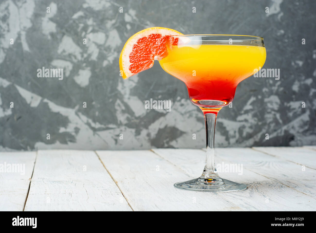 Colorful cocktails close up on concrete background with copy space . Stock Photo